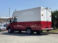 A red and white 2007 GMC C4500 TopKick box truck with a large cargo area and rear doors is displayed in the foreground