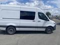 A 2022 Mercedes-Benz Sprinter van in white color with a grey lower body and tinted windows, shown from the side