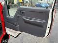The image shows the interior door panel of a 2001 Toyota Dyna featuring a gray plastic surface with a window crank handle and a small rectangular window control panel