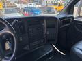 Dashboard of a 2007 GMC C4500 TopKick showing various control knobs buttons and a digital display