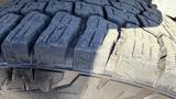 Close-up of a tread pattern on a tire from a 2016 Ford F-150 showcasing deep grooves and rugged design for traction