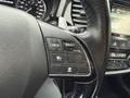 Close-up of the steering wheel controls of a 2016 Mitsubishi Outlander featuring buttons for cruise control and vehicle settings