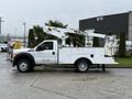 A 2012 Ford F-450 SD bucket truck with a white body and an elevated work platform on the right side
