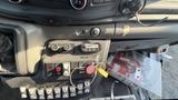 Image shows the control panel of a 2021 Ford Transit featuring various buttons switches and gauges including a fire extinguisher button and door controls