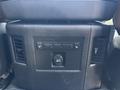 The interior control panel of a 2015 RAM 1500 featuring buttons for heated seats and a power outlet