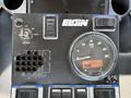 Control panel of a 2012 Autocar Xpert featuring gauges dials buttons and labels for throttle ignition water level and fuel level