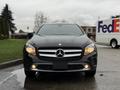 A 2016 Mercedes-Benz GLA-250 in black facing forward with distinctive headlights and the Mercedes logo prominently displayed on the grille