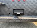 A close-up view of the rear hitch receiver on a 2006 Sterling Acterra with a textured surface and visible lights above it