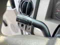 Close-up of the turn signal and windshield wiper control stalk on a 2009 Ford F-550 dashboard
