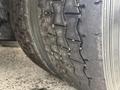 Close-up of a heavily worn tire showing significant tread wear and cracks on a 2013 International Workstar 7500 vehicle