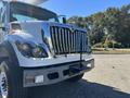 A 2013 International 7500 truck with a prominent chrome grille and front bumper showcasing its robust design and features