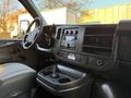 Interior of a 2015 GMC Savana showing the dashboard with control panel and cup holders