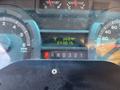 The dashboard of a 2012 Ford Econoline showing trip details an odometer reading of 243015 and indicators for RPM and speed