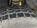 Close-up of a rugged tire tread from a 2009 Ford Econoline showcasing deep grooves and a durable surface designed for traction and stability