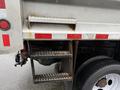 A 2011 Dodge Ram 5500 showing the rear step ladder and tire with visible wear and rust on the metal components