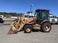 A 2011 Case 570 MXT backhoe loader with an orange and black exterior featuring a front loader bucket and an enclosed cab