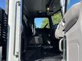Interior view of a 2020 Peterbilt 330 showing the driver's seat dashboard and controls