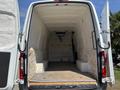 A 2019 Mercedes-Benz Sprinter van with its rear doors open showcasing an empty cargo space with a wooden floor and bare interior walls