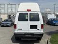 White 2008 Ford Econoline van viewed from the rear with a high roof and no license plate mounted on the back