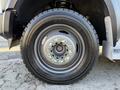 Close-up of a black tire mounted on a silver wheel with visible lug nuts and the Michelin logo on the sidewall of the tire