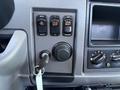 Dashboard controls of a 2019 Peterbilt 337 featuring buttons for cruise control settings and a key ignition switch