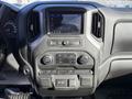 Interior dashboard of a 2024 Chevrolet Silverado 1500 featuring a touchscreen display and control buttons for audio and climate settings