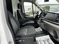 Interior view of a 2021 Ford Transit showcasing two front seats and the dashboard with a navigation display