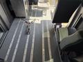 Interior of a 2021 RAM Promaster showing two seats and a flat floor with track systems for securing cargo