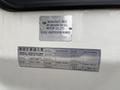 A metal identification plate on a UD Trucks UD 3300 displaying manufacturing details and specifications by Nissan Diesel Motor Co Ltd