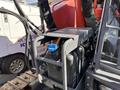 A 2018 Sandvik Ranger DX800 drilling rig with a blue cap on a fluid reservoir and exposed engine components