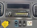 Dashboard controls of a 2016 Freightliner 108SD featuring a radio with Bluetooth capability and various buttons including a parking brake indicator