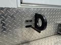 A black wheel crank labeled Wind Free Wheel mounted on a diamond plate surface of a vehicle