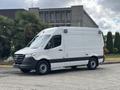 A 2020 Mercedes-Benz Sprinter 2500 white cargo van with a black stripe, side door, and a roof vent is parked on a concrete surface