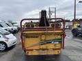 Rear view of a 2015 Vermeer Corporation BC1200XL wood chipper with a yellow body and red frame displaying the model number and company logo