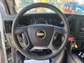 Steering wheel of a 2020 Chevrolet Express featuring the Chevrolet logo controls for audio and cruise control visible on the left side