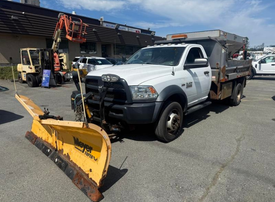 A 2016 RAM 5500 truck with a snow plow attached at the front and a dump bed in the back