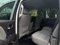 Interior view of a 2016 GMC Sierra 1500 showing the backseat area with gray upholstery and seating for three passengers
