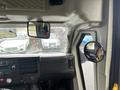 View of the interior dashboard of a 2018 Chevrolet Express featuring a steering wheel multiple control dials and two side mirrors in the driver's area