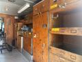 Inside a 2008 Workhorse W62 featuring wooden panels and storage compartments including shelves and cabinets for tools and equipment