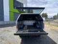 A 2014 Ford F-150 with its tailgate down showing the truck bed which is empty and clean