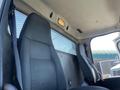 Interior view of a 2007 Freightliner M2 106 showing two gray fabric seats with seatbelts and a ceiling light