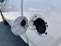 A 2011 Chevrolet Colorado with its gas cap open showing the fuel filler neck and cap inside the fuel door