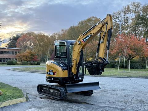A yellow 2023 Sany SY35U compact excavator with a black front blade and rubber tracks parked on a street