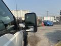 A 2009 Ford F-450 Super Duty with a side mirror visible in the foreground