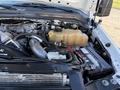 Close-up of the engine compartment of a 2009 Ford F-550 showcasing the engine components battery and coolant reservoir