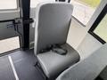 A single gray upholstered passenger seat with a seatbelt, located inside a 2022 Freightliner B2 bus