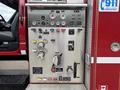 Control panel of a fire truck featuring various gauges switches and valves for operating equipment such as pumps and water supply