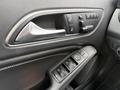 Interior door panel of a 2016 Mercedes-Benz GLA-250 featuring controls for windows locks and mirrors in a sleek design with leather finishing