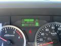 Dashboard of a 2022 Isuzu NQR showing hour meter reading 8910.0 H and gear indicators including PRND21 at the bottom