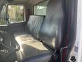 Interior view of a 2008 International 4400 showing a black leather driver's seat and a passenger seat with a simplistic dashboard layout